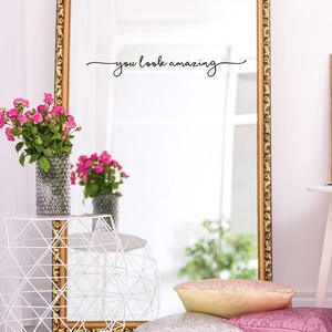 Black 'you look amazing' script wall sticker applied to a modern gold-framed mirror