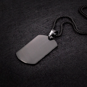 Detailed view of a matte black stainless steel dog tag pendant and matching box chain