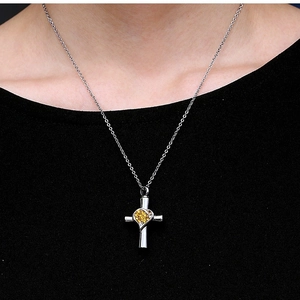 Silver heart cross pendant necklace with yellow zircon stones on a stainless steel chain