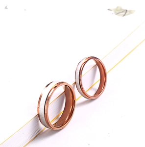 Close-up of brushed silver and rose gold polished stainless steel couple rings