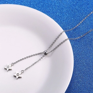 Silver star pendant necklace with cubic zirconia and adjustable chain on white plate