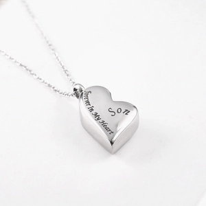Macro detail of silver heart urn necklace engraved with Forever In My Heart Son text
