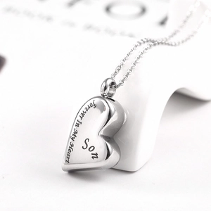Macro shot of silver heart urn necklace with Forever In My Heart Son engraving