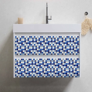 Detail of blue mosaic tile stickers applied to a white bathroom drawer for decoration