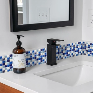 Detail of blue and white mosaic tile border sticker applied on a bathroom vanity backsplash