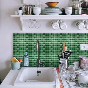 Detail of green 3D mosaic tile stickers applied on a kitchen backsplash wall