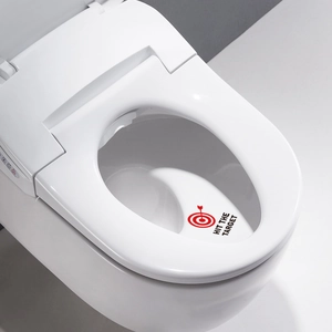 Modern white toilet seat featuring Hit the Target bullseye sticker and side control panel