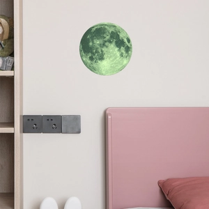Detailed realistic moon wall sticker with green glow-in-the-dark texture on bedroom wall