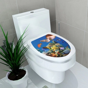 Close-up of 3D sea turtle and tropical fish stickers on an oval toilet seat lid cover