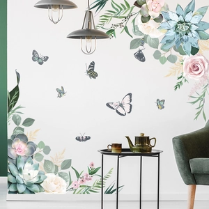 Detail view of floral wall stickers with butterflies on a white living room wall