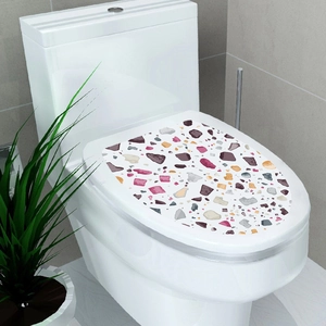 Close-up of colorful terrazzo pattern toilet seat cover sticker in a modern bathroom