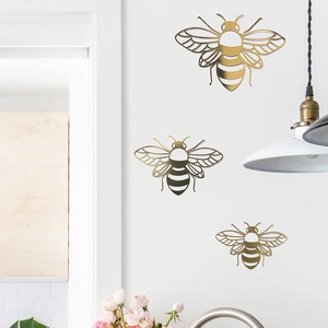 Detailed view of hollow out golden bee wall stickers with intricate wing patterns