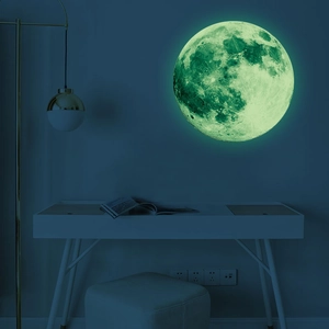Luminous moon wall sticker showing realistic green glow texture in a dark bedroom setting