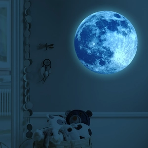 Detailed blue glowing 30cm moon wall sticker with realistic craters in a dark bedroom