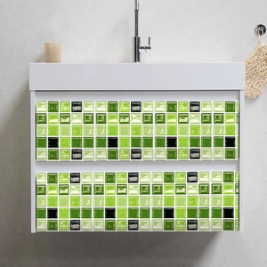 Detail of green and black mosaic tile stickers applied on a white bathroom vanity drawer