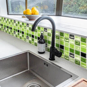Glossy green mosaic tile stickers on kitchen backsplash with a modern faucet