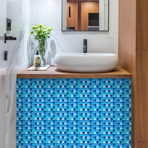 Blue mosaic tile stickers applied to a modern bathroom vanity for a waterproof finish