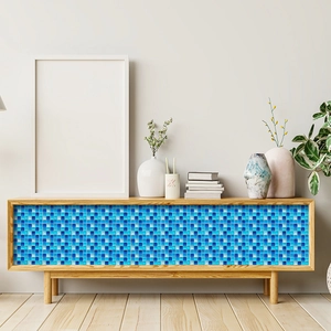 Detailed view of blue mosaic wall stickers applied on a wooden cabinet front door