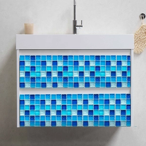Close-up of blue mosaic tile sticker applied on a white bathroom cabinet drawer