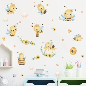 Detail view of cartoon bee and sunflower wall stickers in a cozy nursery room setting