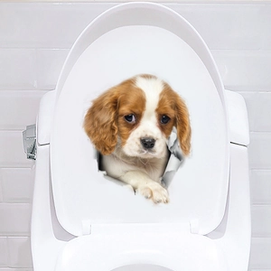 Sticker 3D réaliste d'un chiot Cavalier King Charles avec un effet de trou déchiré
