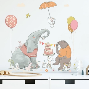 Detailed view of cartoon elephant, bear and cake wall stickers in a cozy nursery room