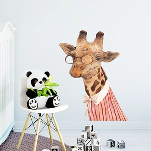 Detailed view of cartoon giraffe wall decal in a cozy white nursery with a crib