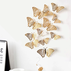 Pegatinas de pared de mariposas 3D caladas doradas con patrones florales decorativas