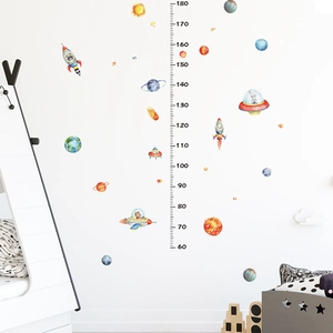 Detailed view of space-themed height chart with rocket and planet stickers for kids