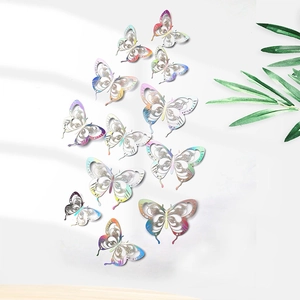Close-up of laser-cut 3D paper butterflies with iridescent finish on white wall