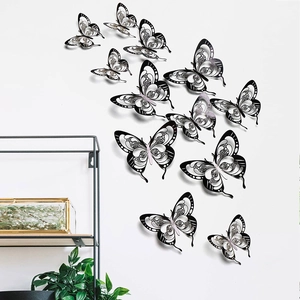 Detailed macro view of 3D black hollow butterfly wall stickers on a minimalist white wall