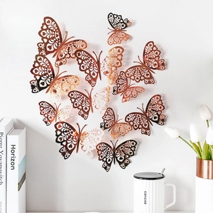 Detailed macro view of rose gold hollow butterfly wall decor stickers in various sizes