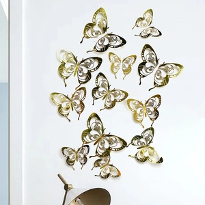 Detail of gold hollow butterfly wall stickers with intricate texture on a white wall