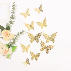 Golden hollow butterfly wall stickers with intricate patterns on a white wall