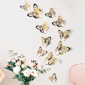 Detailed view of 3D gold hollow butterfly wall stickers arranged on a white background