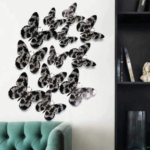 3D butterfly wall stickers with black and white ink patterns on a modern white wall