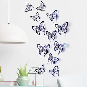 Detail of 3D hollow blue butterfly wall decals with laser-cut patterns on a white wall