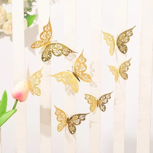 Detailed view of seven 3D laser-cut golden mirror paper butterflies on a white wooden wall
