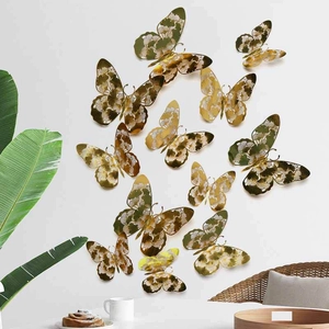 Set of 12 golden hollow butterfly wall stickers with intricate floral patterns for decor