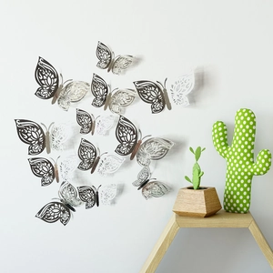 Detailed macro view of 3D metallic hollow butterfly wall stickers on a white background