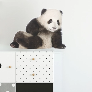 Adorable giant panda wall sticker for kids bedroom on a modern white drawer chest