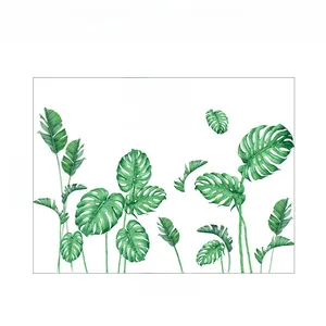 Detail of botanical wall stickers with monstera and palm leaves plus artistic text