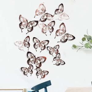 Macro view of 3D hollow rose gold butterfly wall stickers with detailed cutout patterns