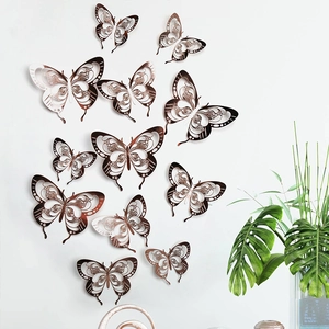 Detailed view of 3D hollow butterfly wall stickers in rose gold on a minimalist white wall