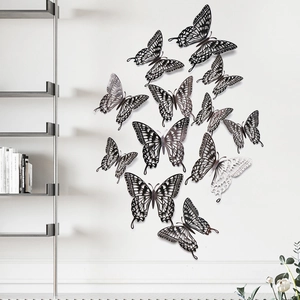 Detailed view of hollow carved metal butterfly wall stickers on a clean white wall