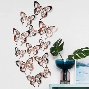 Detailed view of rose gold 3D cutout butterfly wall decals in a stylish home setting