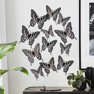 Macro detail of hollow decorative butterflies in an elegant circular pattern on white wall