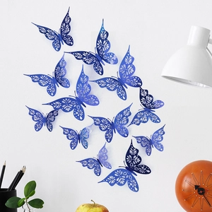 Close-up of laser-cut dark blue butterfly wall decor set on a clean white background
