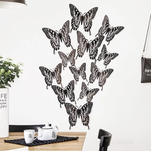 Detailed view of 12pcs black 3D hollow butterfly wall stickers in a modern home interior
