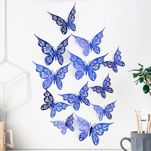 Macro detail of blue hollow laser-cut 3D butterfly wall stickers on a white wall